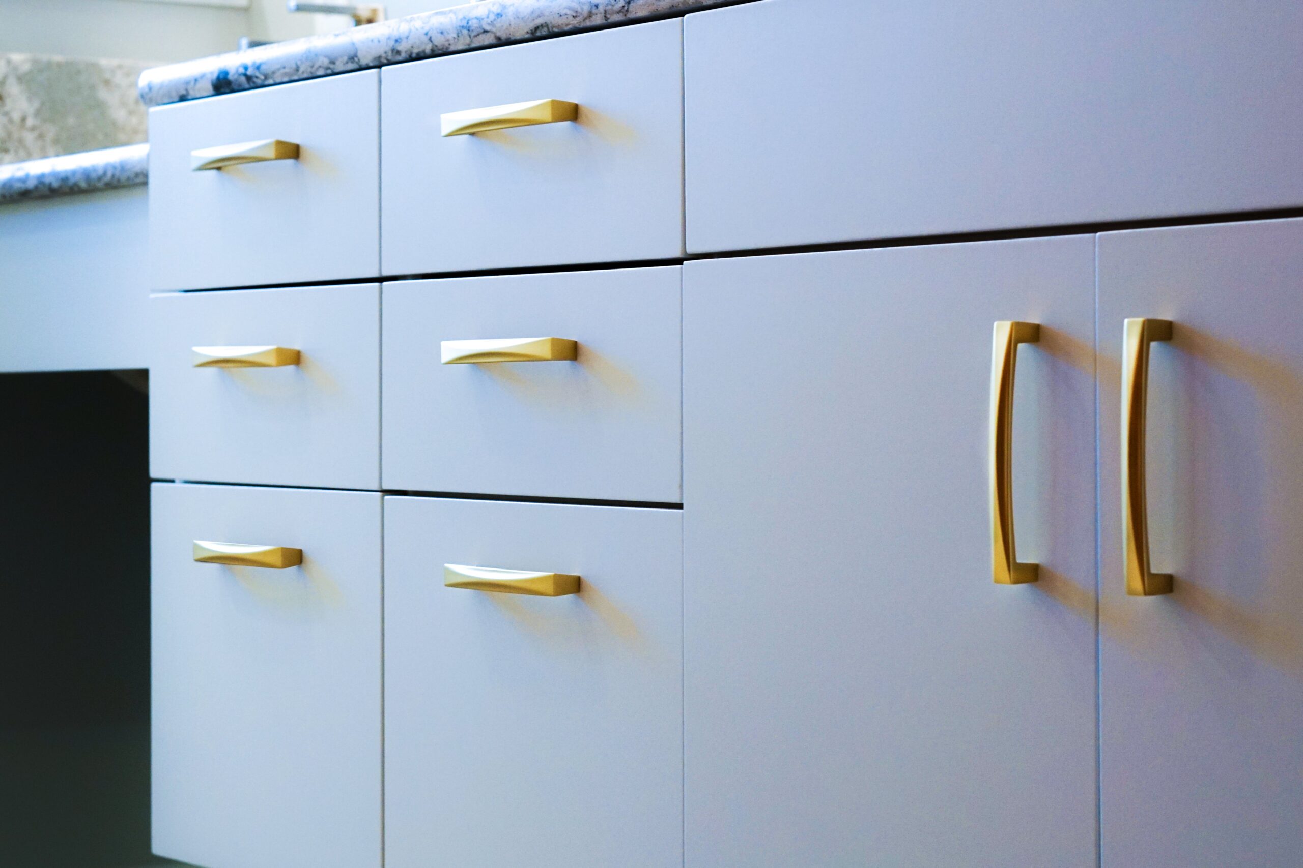 white bathroom cabinets with gold handles