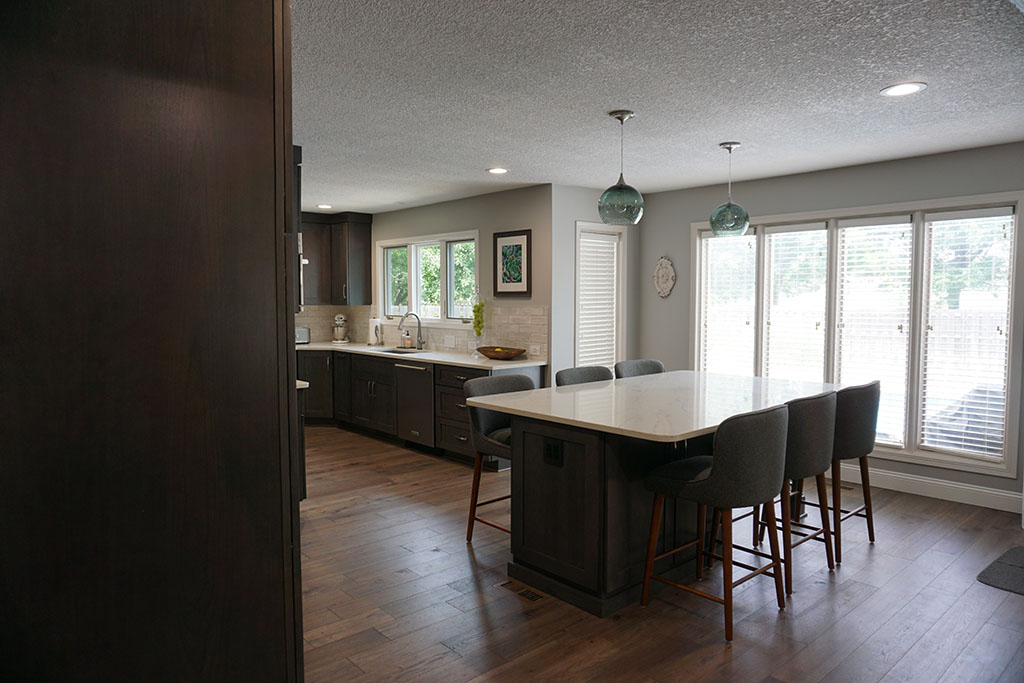 wood floor dining area connected to kitchen