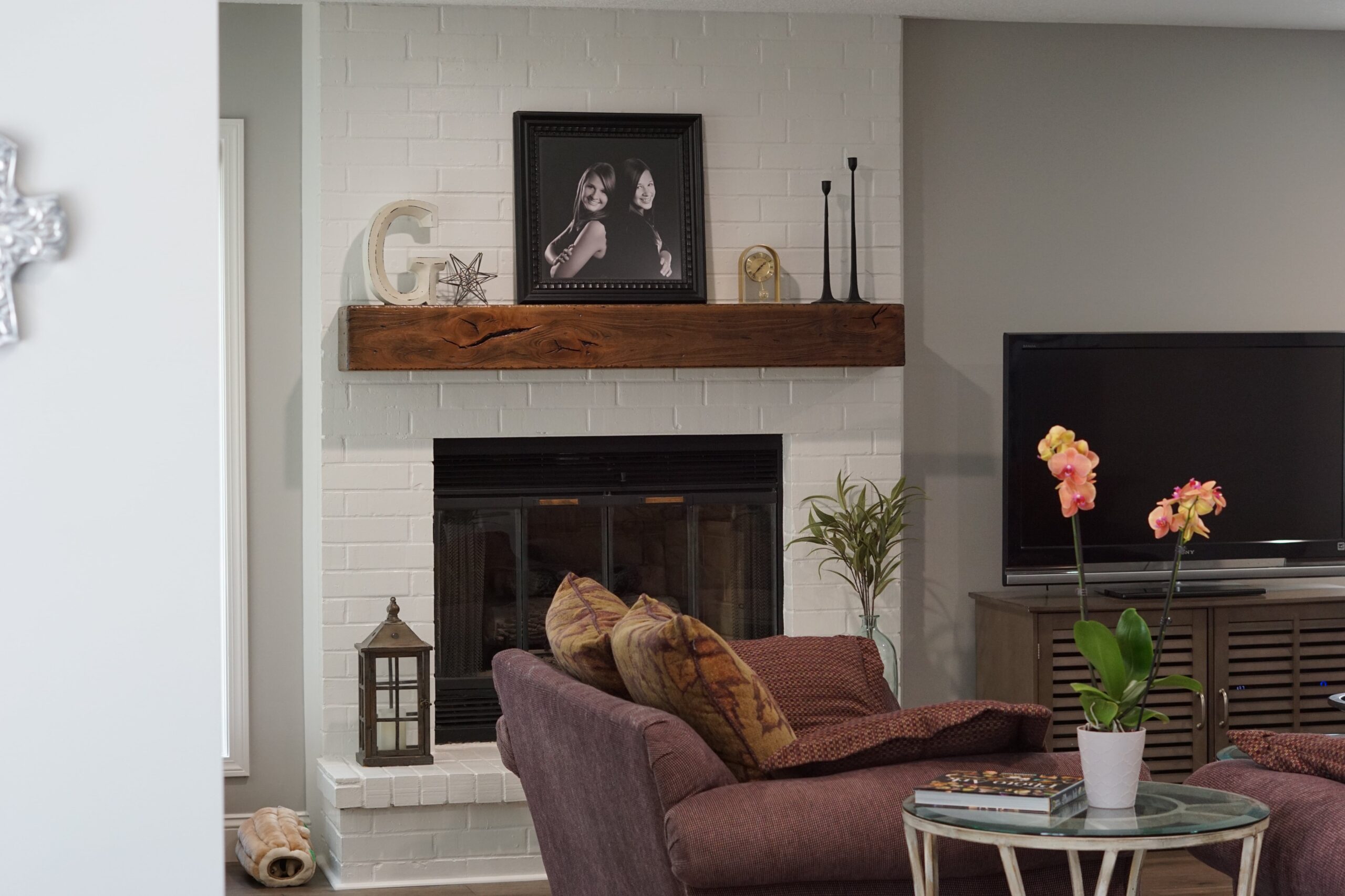 white brick fire place with wooden accents