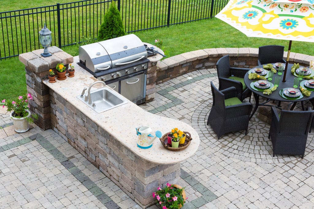 brick outdoor kitchen with table